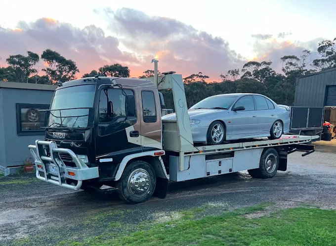 Silver Holden Commodore on the Seaco tilt tray at sunset