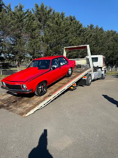 Red Holden Torana secured on the Seaco Towing tilt tray
